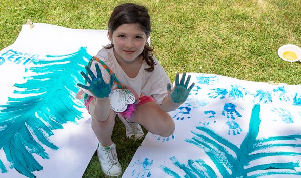 Young camper finger painting